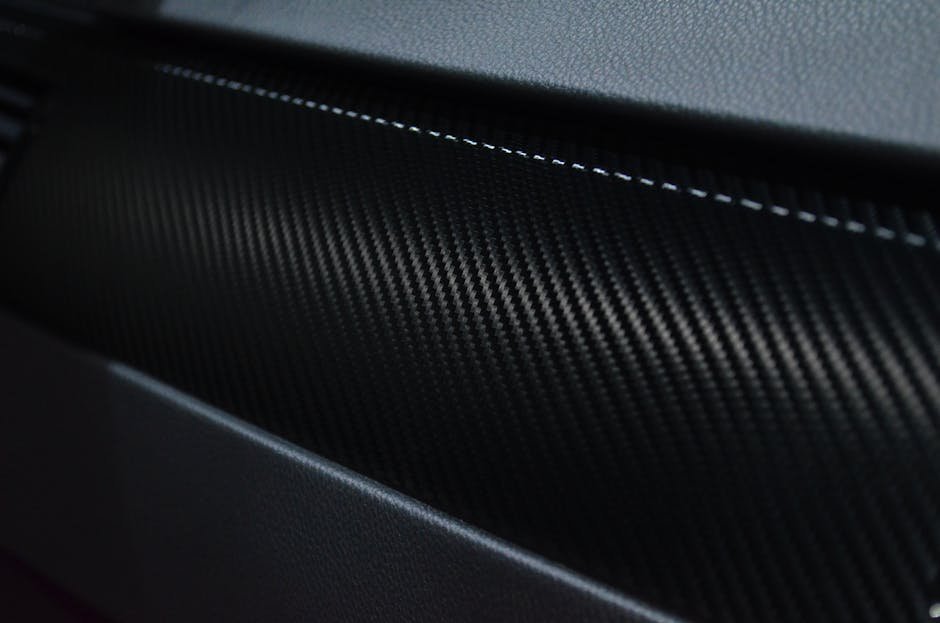 Detailed view of a carbon fiber texture on a car interior showcasing modern design.